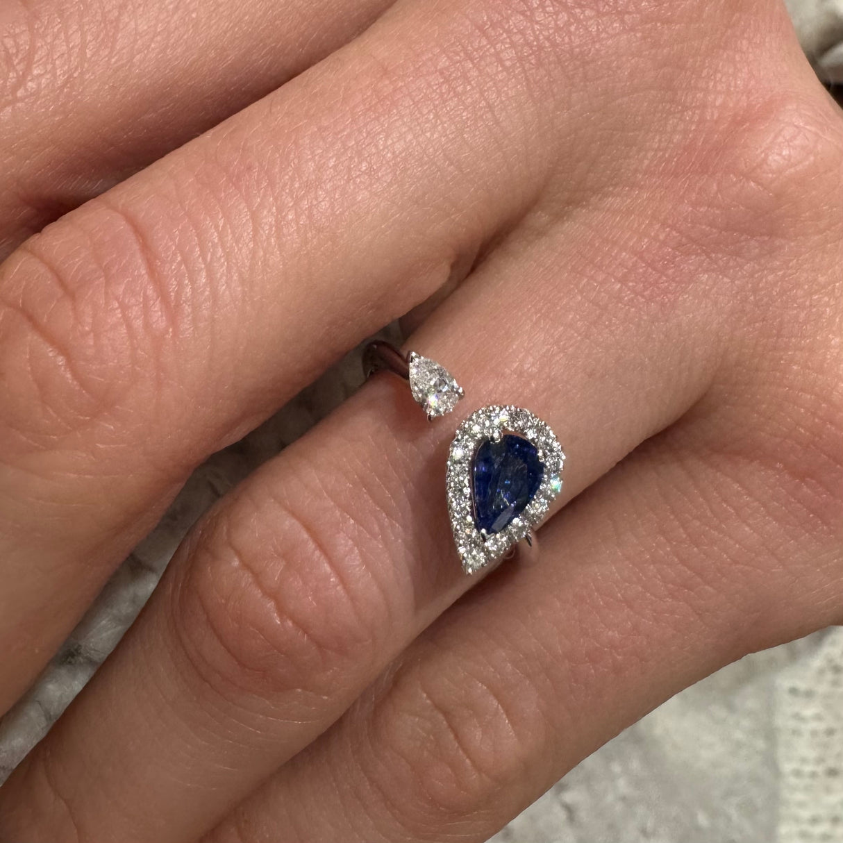 Open ring with sapphire drop and white gold diamonds