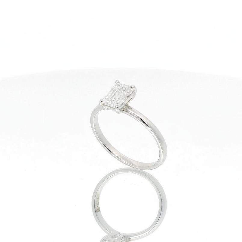 Ring solitaire emerald cut diamond white gold angled
