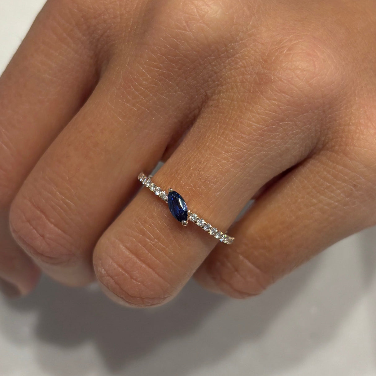 White diamond ring and central blue sapphire